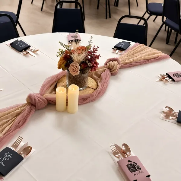 Customer photo of personalized custom koozies used in an event table display with floral decor.