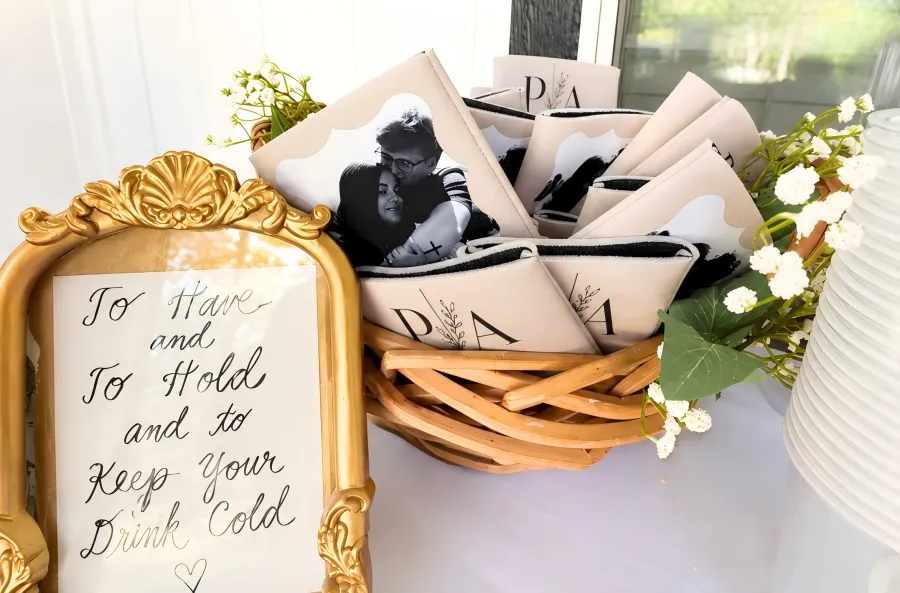 Custom wedding koozies displayed in a basket as personalized wedding favors for guests
